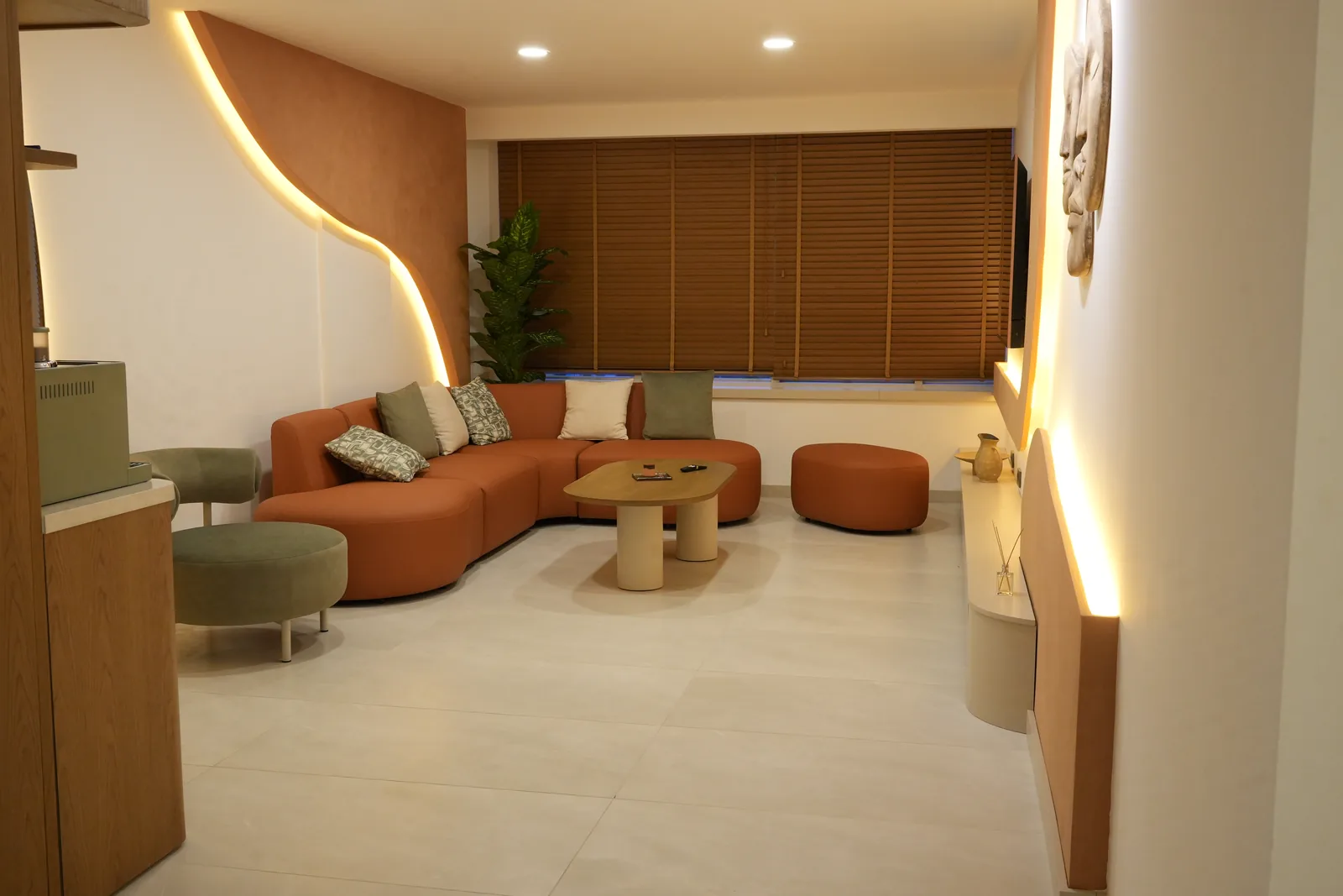 Waiting lounge of the practice in Antalya — terracotta modular seating and concealed lighting